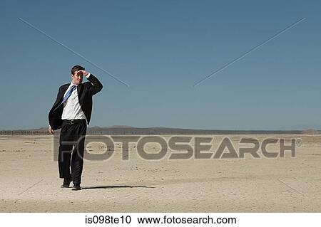 Businessman in desert View Large Photo Image Stock Image - Businessman in desert. Fotosearch
