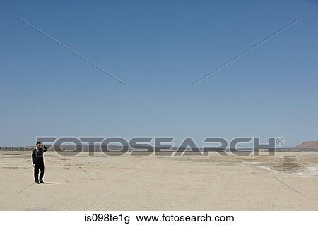Businessman in desert View Large Photo Image Stock Image - Businessman in desert. Fotosearch