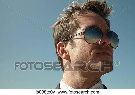 Businessman with desert reflected in sunglasses View Large Photo Image Stock Photo - Businessman with desert reflected in sunglasses. Fotosearch