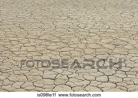 Stock Image - Cracked surface of dry lake bed. Fotosearch
