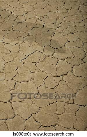 Cracked surface of dry lake bed with shadow View Large Photo Image Stock Photograph - Cracked surface of dry lake bed with shadow. Fotosearch