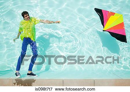 Man in pool with kite View Large Photo Image Stock Photo - Man in pool with kite. Fotosearch