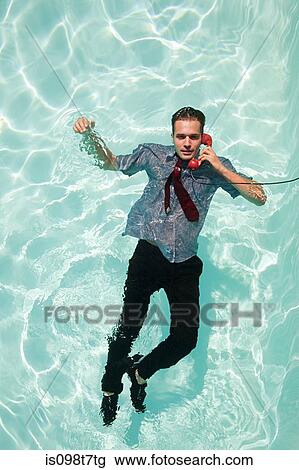 Office worker on telephone in swimming pool View Large Photo Image Stock Image - Office worker on telephone in swimming pool. Fotosearch