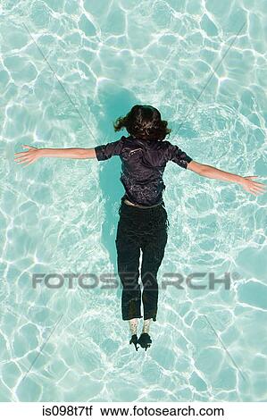 Stock Image - Woman face down in swimming pool. Fotosearch