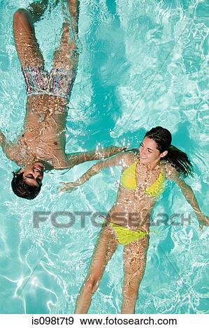 Stock Photo - Young couple in swimming pool. Fotosearch