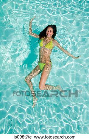 Stock Image - Young woman in swimming pool. Fotosearch
