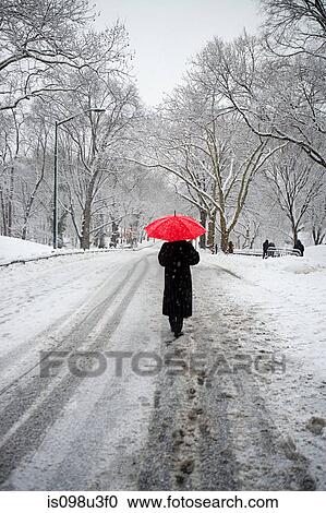Person with red umbrella walking in snow View Large Photo Image Stock Image - Person with red umbrella walking in snow. Fotosearch