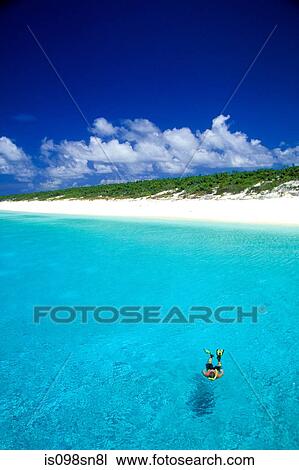 Snorkeler by remote island. View Large Photo Image Stock Image - Snorkeler by remote island.. Fotosearch