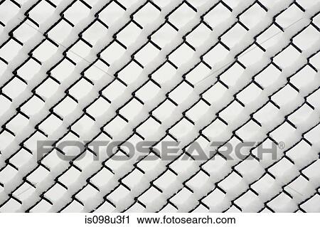 Stock Image - Snow on a chain link fence. Fotosearch
