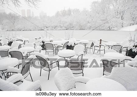 Snow on chairs in the park View Large Photo Image Stock Photo - Snow on chairs in the park. Fotosearch