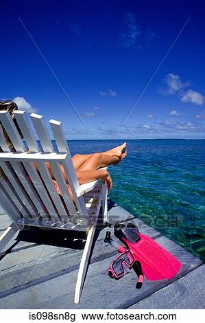 Woman relaxes on dock. View Large Photo Image Stock Image - Woman relaxes on dock.. Fotosearch