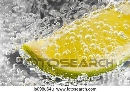 Abstract of lime and bubbles in a gin and tonic View Large Photo Image Stock Photograph - Abstract of lime and bubbles in a gin and tonic. Fotosearch