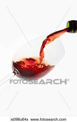 Bottle of red wine being poured into wine glass View Large Photo Image Stock Photo - Bottle of red wine being poured into wine glass. Fotosearch