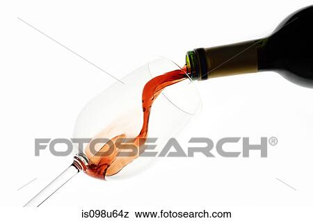 Stock Photo - Bottle of red wine being poured into wine glass. Fotosearch