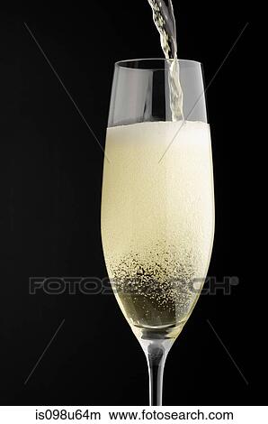 Picture - Champagne being poured into champagne glass. Fotosearch