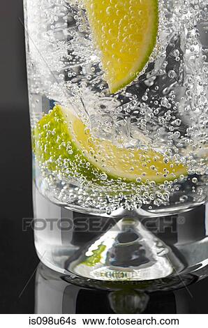 Lime and bubbles in a gin and tonic View Large Photo Image Stock Photograph - Lime and bubbles in a gin and tonic. Fotosearch
