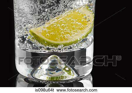 Lime and bubbles in a gin and tonic View Large Photo Image Stock Photograph - Lime and bubbles in a gin and tonic. Fotosearch