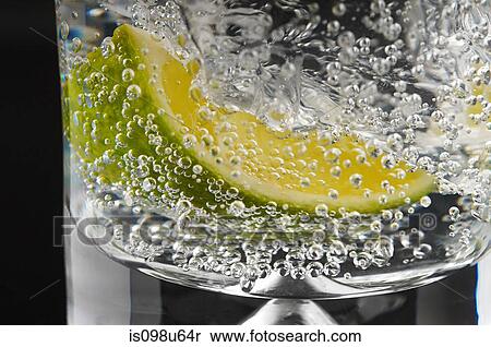 Lime and bubbles in a gin and tonic View Large Photo Image Stock Photography - Lime and bubbles in a gin and tonic. Fotosearch