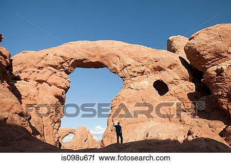 Person standing under Turret Arch, Arches National Park, Moab, Utah, USA View Large Photo Image Stock Image - Person standing under Turret Arch, Arches National Park, Moab, Utah, USA. Fotosearch