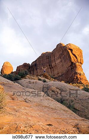 Tourist near Balanced Rock, Grand County, Utah, USA View Large Photo Image Stock Photo - Tourist near Balanced Rock, Grand County, Utah, USA. Fotosearch