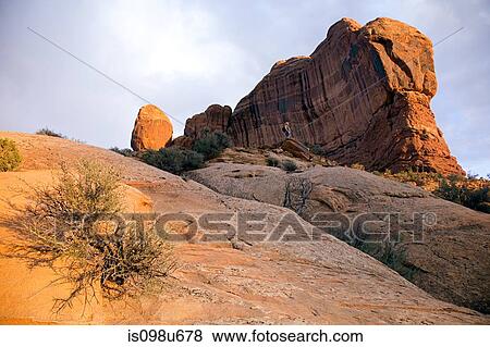 Tourist near Balanced Rock, Grand County, Utah, USA View Large Photo Image Stock Photo - Tourist near Balanced Rock, Grand County, Utah, USA. Fotosearch