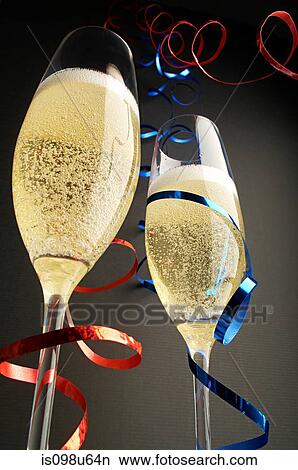 Two champagne glasses with red and blue streamers View Large Photo Image Picture - Two champagne glasses with red and blue streamers. Fotosearch