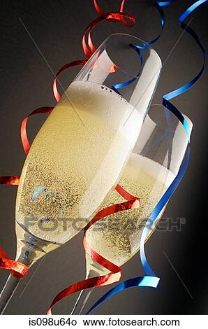 Two champagne glasses with red and blue streamers View Large Photo Image Picture - Two champagne glasses with red and blue streamers. Fotosearch