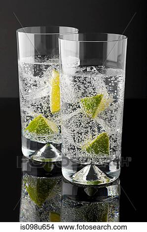 Picture - Two tumblers with gin and tonic. Fotosearch
