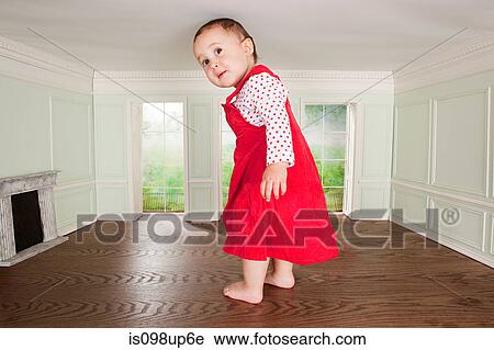 Big toddler girl in a tiny room View Large Photo Image Stock Image - Big toddler girl in a tiny room. Fotosearch
