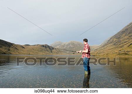 Man fishing in lake View Large Photo Image Picture - Man fishing in lake. Fotosearch