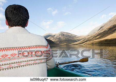 Man in rowing boat on lake View Large Photo Image Stock Photo - Man in rowing boat on lake. Fotosearch