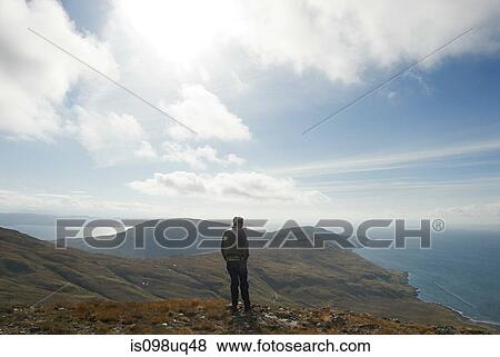Stock Photo - Man looking at view of landscape. Fotosearch