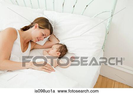 Mother watching baby girl sleep View Large Photo Image Stock Image - Mother watching baby girl sleep. Fotosearch