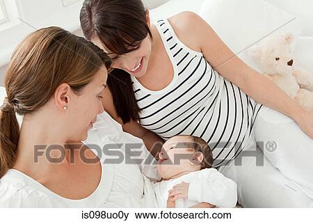 Mother with baby girl and pregnant friend View Large Photo Image Stock Photo - Mother with baby girl and pregnant friend. Fotosearch