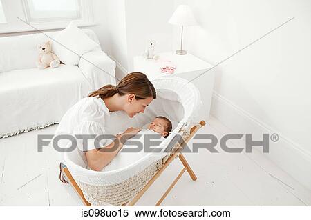 Mother with baby in bassinet View Large Photo Image Stock Photography - Mother with baby in bassinet. Fotosearch