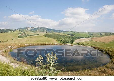 Pond and fields near Volterra, Tuscany, Italy View Large Photo Image Stock Image - Pond and fields near Volterra, Tuscany, Italy. Fotosearch
