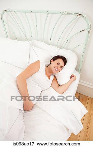 Pregnant woman lying in bed View Large Photo Image Stock Photo - Pregnant woman lying in bed. Fotosearch