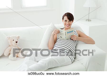 Pregnant woman with baby name book View Large Photo Image Stock Photograph - Pregnant woman with baby name book. Fotosearch
