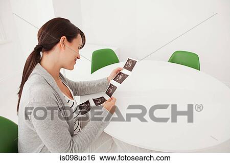 Pregnant woman with baby scan View Large Photo Image Stock Photograph - Pregnant woman with baby scan. Fotosearch