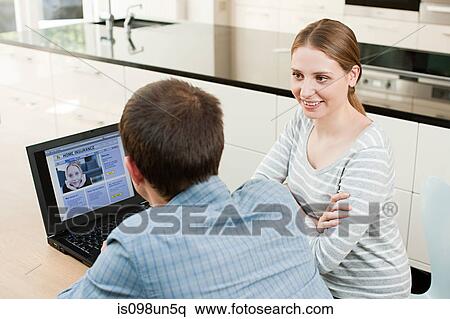 Young couple looking at insurance on laptop View Large Photo Image Stock Photography - Young couple looking at insurance on laptop. Fotosearch