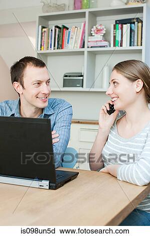 Young couple using laptop View Large Photo Image Stock Image - Young couple using laptop. Fotosearch