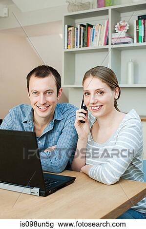 Young couple using laptop View Large Photo Image Stock Image - Young couple using laptop. Fotosearch