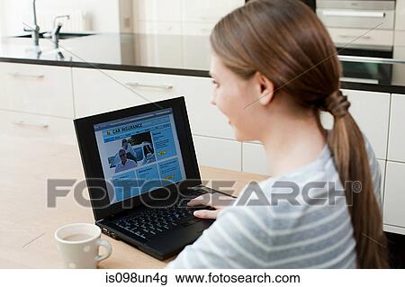 Young woman looking at car insurance on laptop View Large Photo Image Stock Image - Young woman looking at car insurance on laptop. Fotosearch