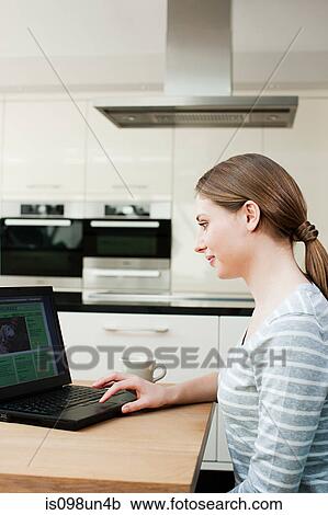 Young woman looking at pet insurance on laptop View Large Photo Image Stock Image - Young woman looking at pet insurance on laptop. Fotosearch