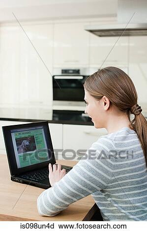 Young woman looking at pet insurance on laptop View Large Photo Image Stock Image - Young woman looking at pet insurance on laptop. Fotosearch