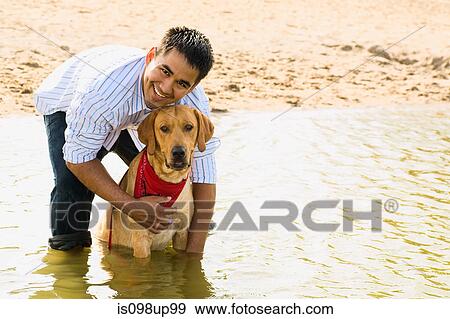 Man and golden retriever in the sea View Large Photo Image Stock Photo - Man and golden retriever in the sea. Fotosearch
