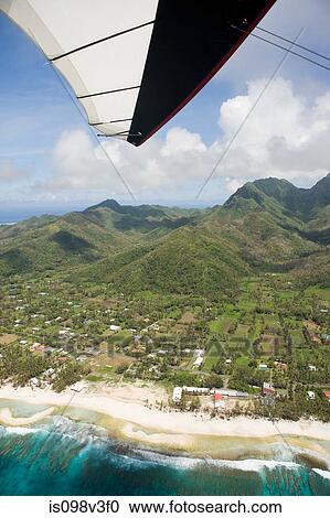 Stock Image - Aerial view from paraglider of Cook Islands coastline. Fotosearch
