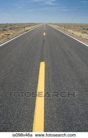 Stock Image - Empty road in desert. Fotosearch