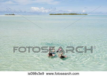 Mid adult couple snorkeling and looking at fish View Large Photo Image Stock Photo - Mid adult couple snorkeling and looking at fish. Fotosearch