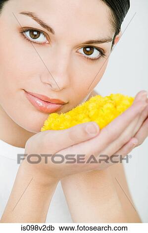 Portrait of young brunette woman holding yellow petals View Large Photo Image Stock Image - Portrait of young brunette woman holding yellow petals. Fotosearch